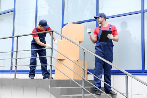 Removalists handling furniture in a Westminster flat