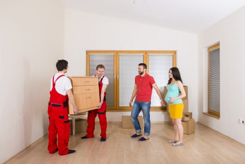 Trained movers handling furniture carefully during a Westminster move