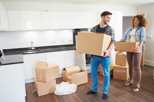 Mover handling boxes and furniture in a Westminster flat or apartment building